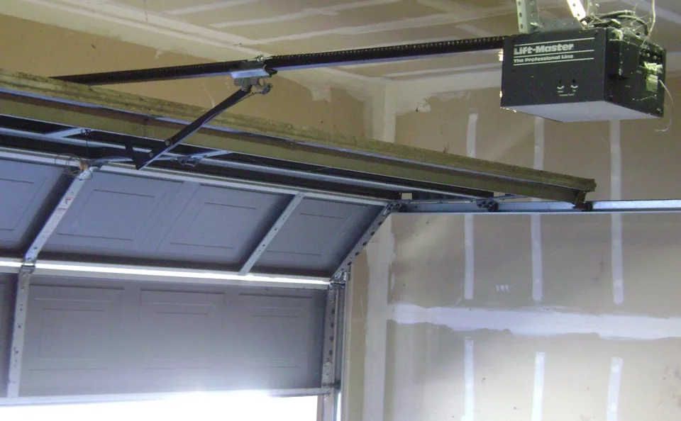 Ceiling-mounted LiftMaster chain-drive garage door opener with its motor housing and drive rail.